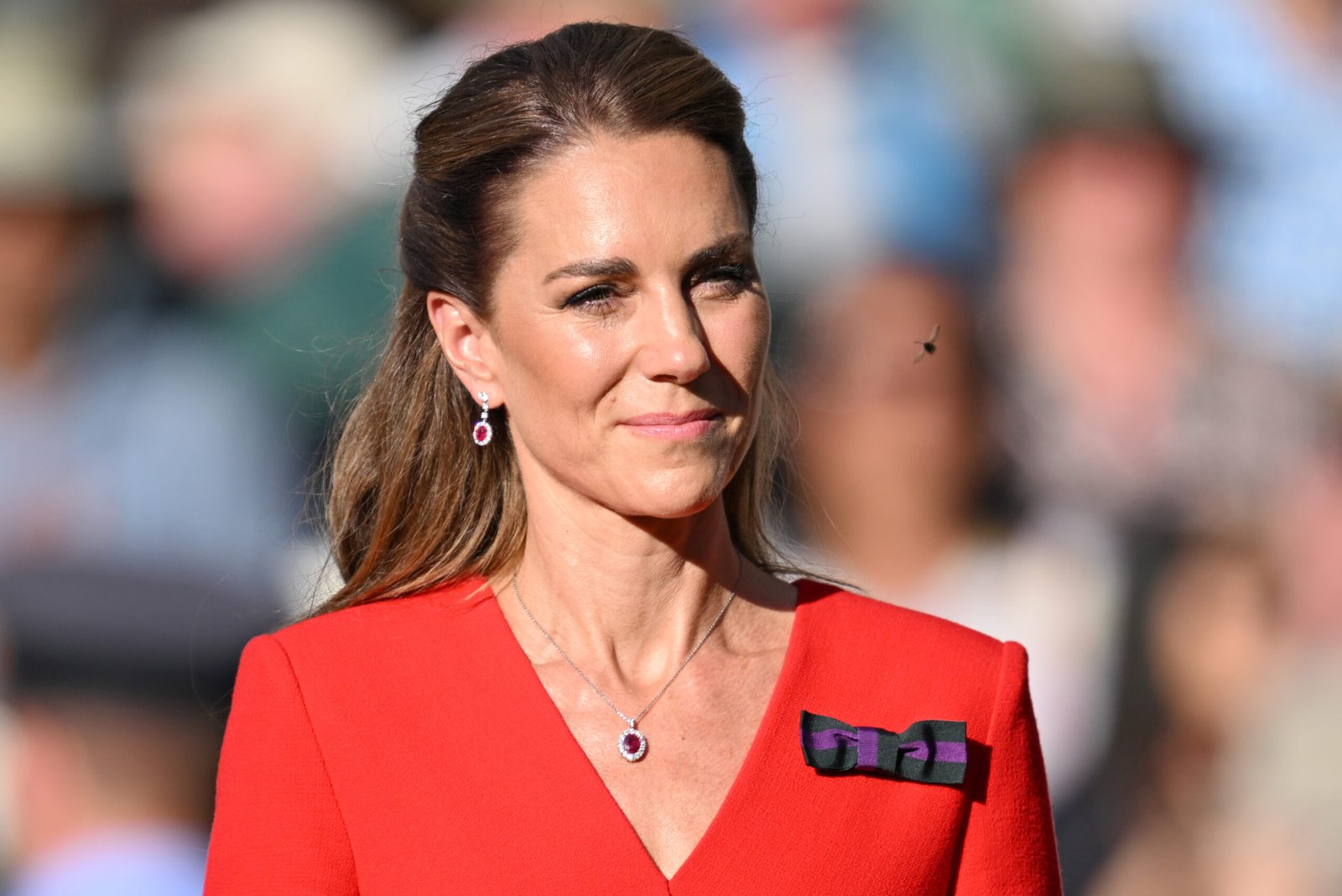 A close-up of Catherine's outfit makes the purple-and-green Wimbledon bow easy to spot. The ribbon has become a familiar feature of her Championships wardrobe and reflects her connection to the tournament.