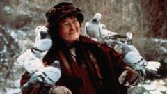 Brenda Fricker with several birds perched on her arms in a scene from Home Alone 2