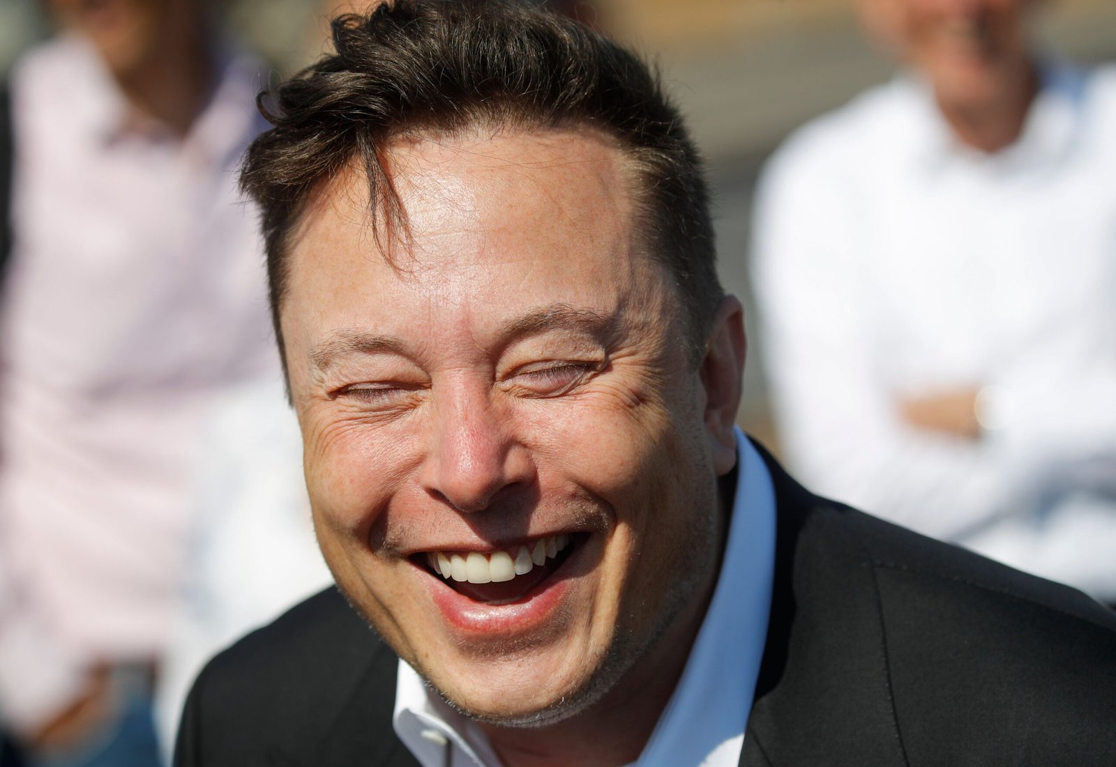 Tesla CEO Elon Musk laughs as he talks to media as he arrives to visit the construction site of the future US electric car giant Tesla, on September 03, 2020 in Gruenheide near Berlin.