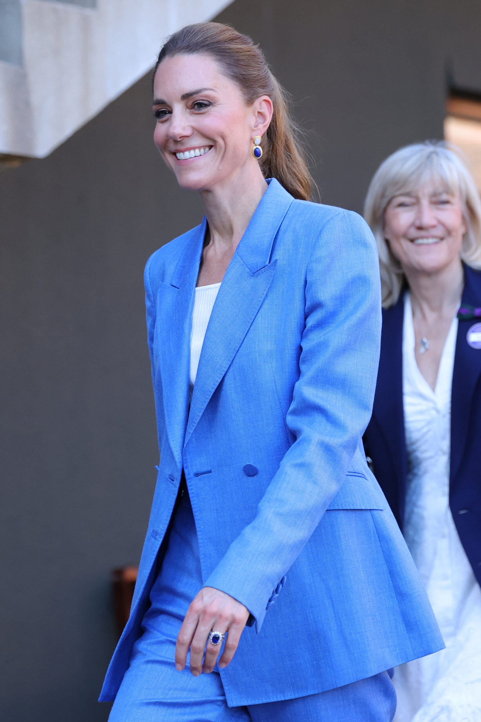 Catherine wore her hair in a wavy ponytail, a noticeable change from the loose waves she often favors at Wimbledon. The hairstyle complemented the modern tailoring of her blue suit.