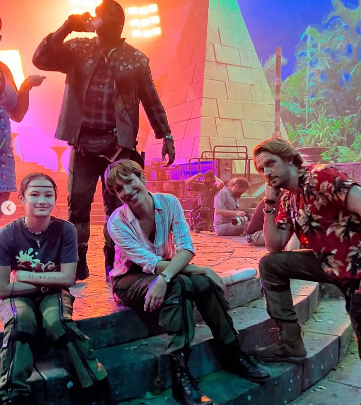 Kaylee Hottle poses with Rebecca Hall and fellow "Godzilla" cast members Brian Tyree Henry and Dan Stevens in a behind-the-scenes photo from the set of "Godzilla x Kong: The New Empire."