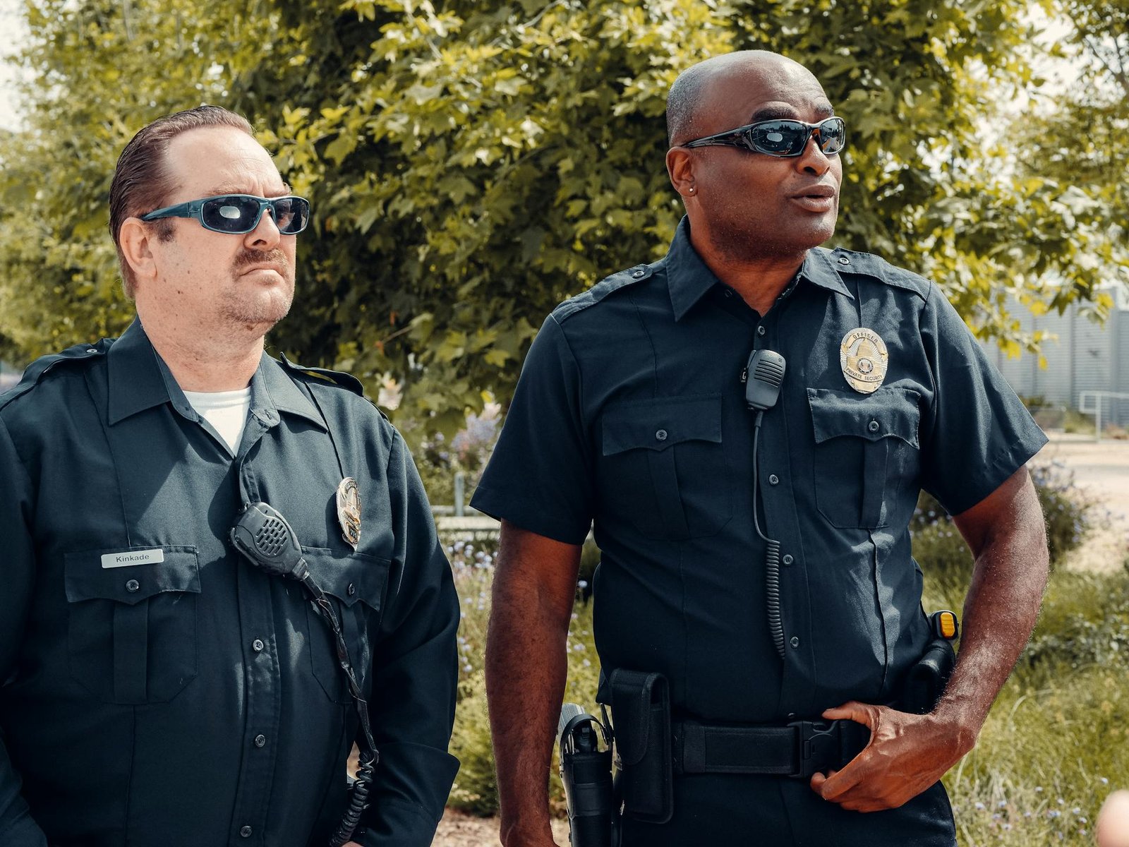 Two police officers outside a house