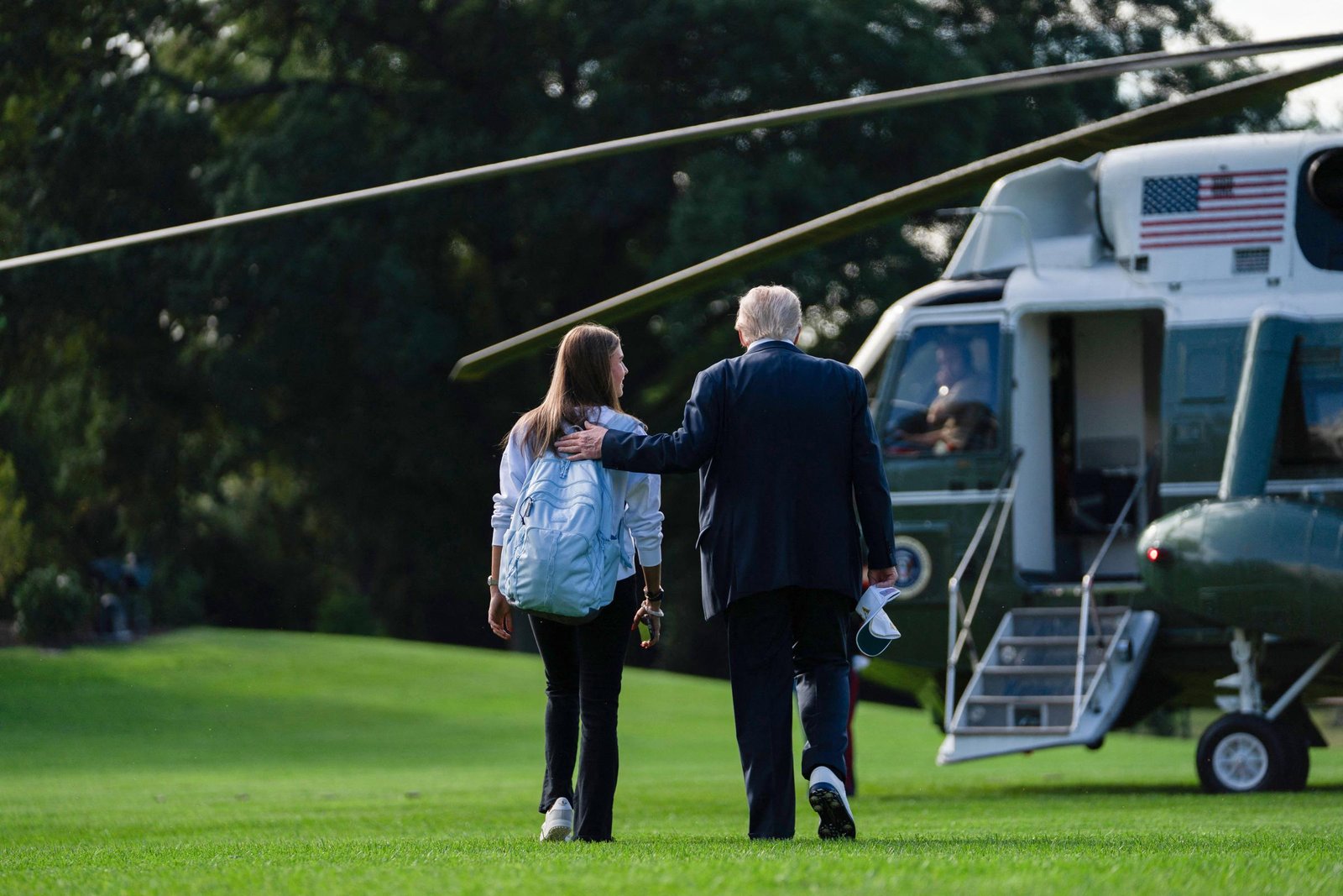 Donald Trump walks to board Marine One with his granddaughter Kai Trump on the South Lawn of the White House in Washington, DC, on September 26, 2025