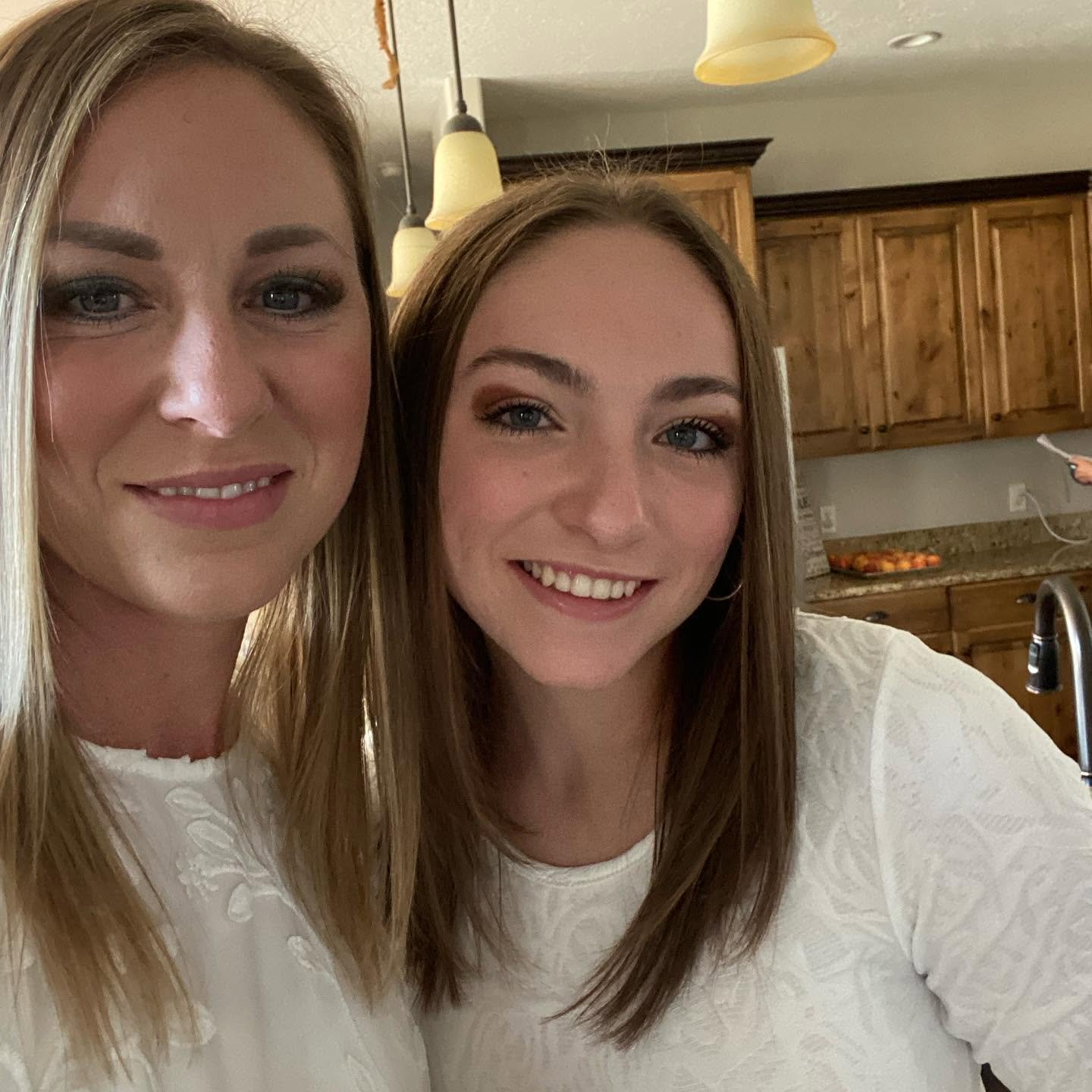 Katrina Long (left) and daughter Lydia (right) lean in close for a beaming indoor selfie, showing the strong resemblance and unbreakable bond shared between mother and daughter.
